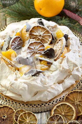 Image of Pavlova with spicy cream with Christmas decor.