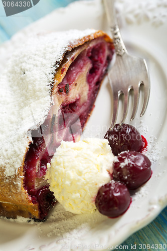 Image of Plate with cherry strudel and fork.
