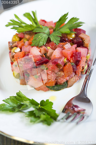 Image of Traditional Russian beetroot salad, vegetables and a spicy sauce