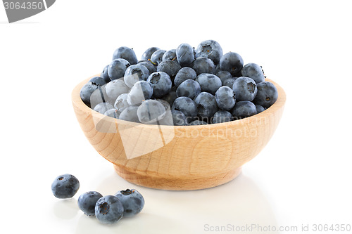 Image of Blueberry fruit in a wooden bowl .