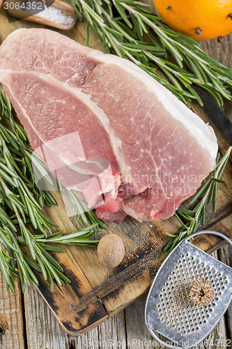 Image of Fresh pork and rosemary close up.