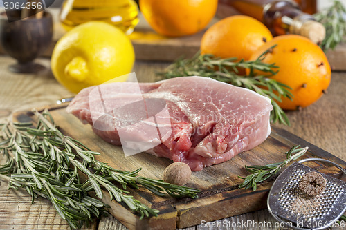 Image of Piece of pork and rosemary.