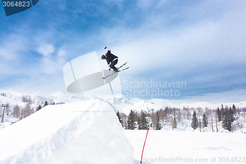 Image of Free style skier performing a high jump