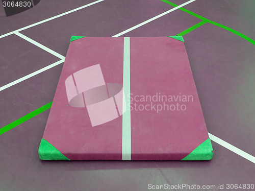 Image of Very old red mat on a blue court