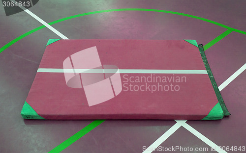Image of Very old red mat on a blue court