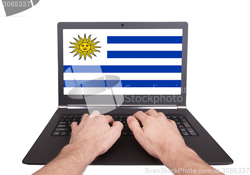 Image of Hands working on laptop, Uruguay