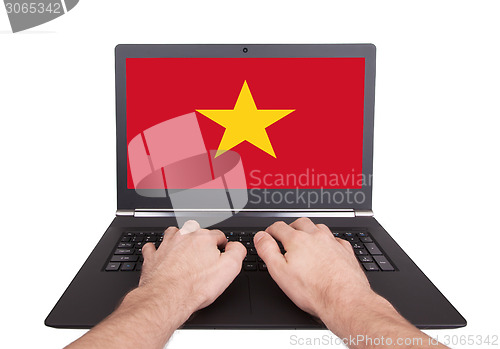 Image of Hands working on laptop, Vietnam