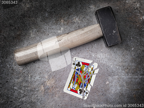 Image of Hammer with a broken card, jack of clubs