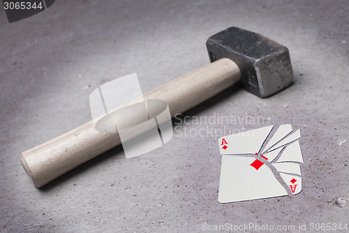 Image of Hammer with a broken card, ace of diamonds