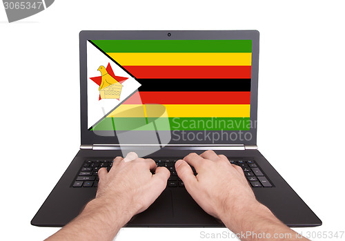 Image of Hands working on laptop, Zimbabwe