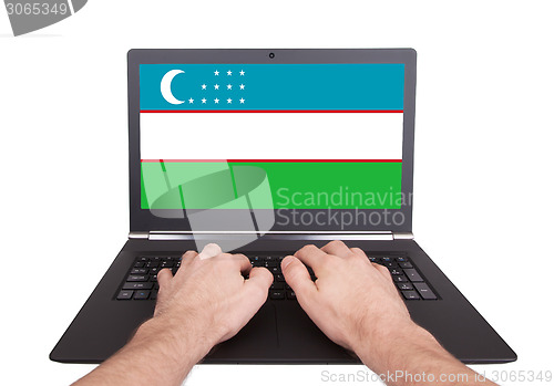 Image of Hands working on laptop, Uzbekistan