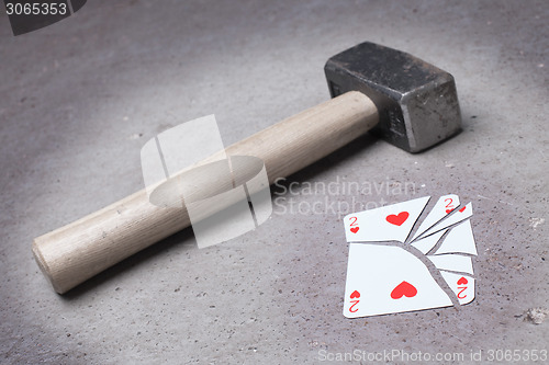 Image of Hammer with a broken card, two of hearts