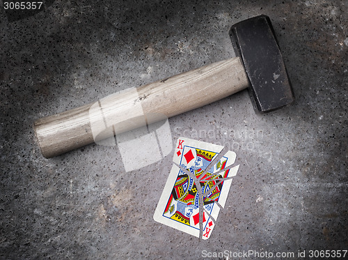 Image of Hammer with a broken card, king of diamonds