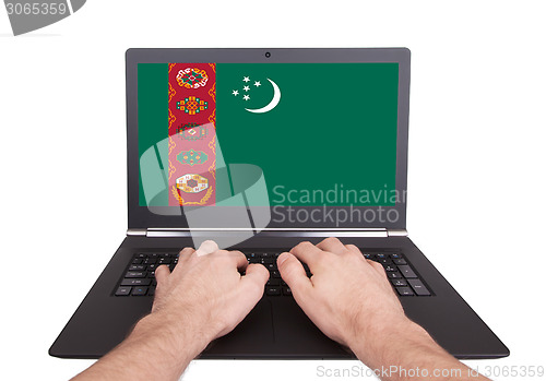 Image of Hands working on laptop, Turkmenistan