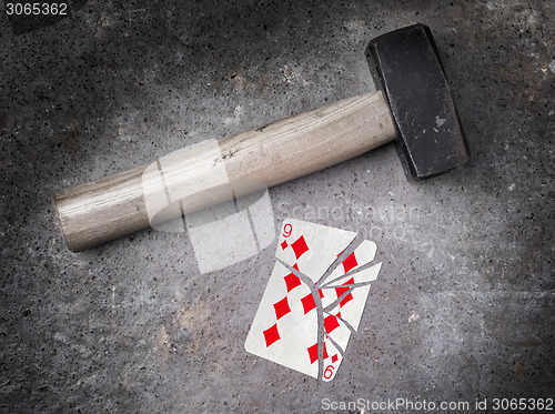 Image of Hammer with a broken card, nine of diamonds