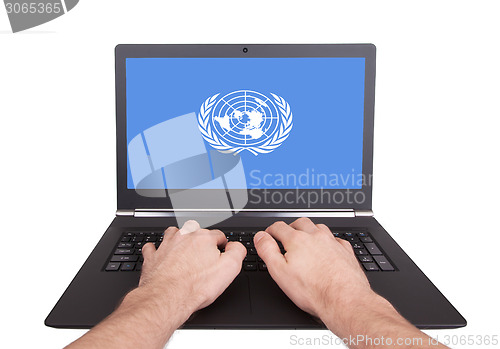 Image of Hands working on laptop, United Nations