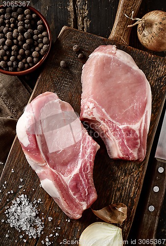 Image of fresh raw meat on wooden cutting board