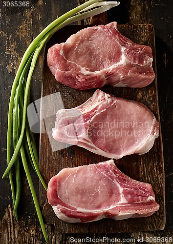 Image of fresh raw meat on wooden cutting board