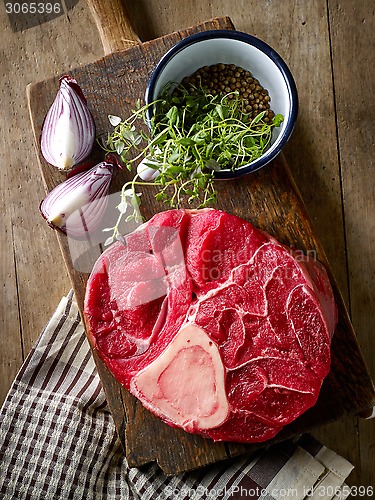 Image of fresh raw meat on wooden cutting board