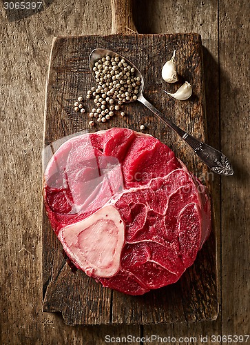 Image of fresh raw meat on wooden cutting board