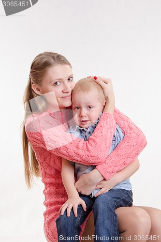 Image of Young mother calms her son