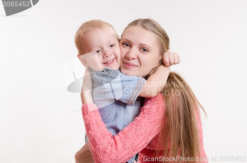 Image of The three-year boy hugging his mother