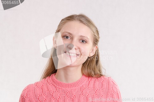 Image of Portrait of smiling girl on a light background