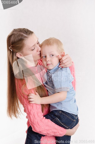 Image of Mum holds on hands of three sons