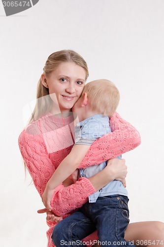 Image of Joyful mother calms her son