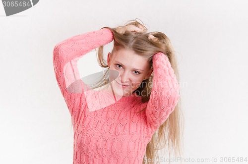 Image of Happy girl holding her hair