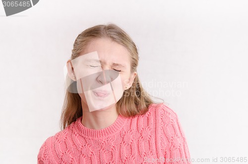 Image of Young girl closed her eyes and pulled language