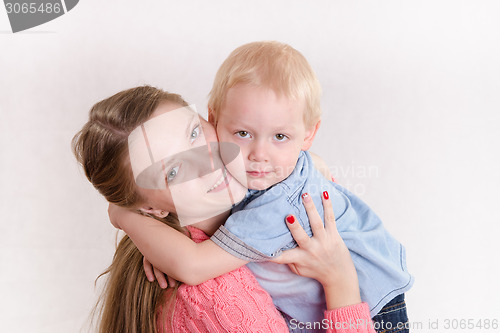 Image of Young girl hugging her son