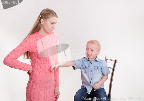 Image of Young mother selected a toy my son