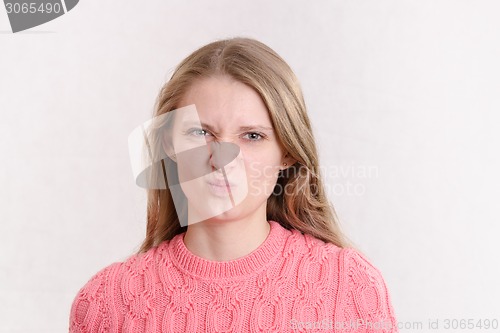 Image of young girl looks in disgust frame