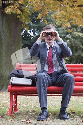 Image of Businessman searching with binoculars