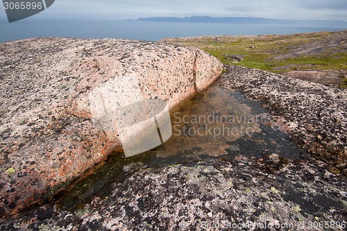 Image of fresh water in rock among salty ocean