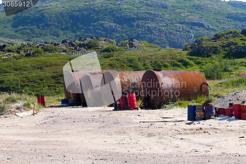 Image of gas station in mountains i Arctic with barrels