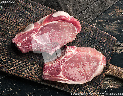 Image of fresh raw meat on wooden cutting board