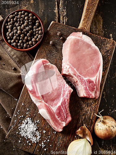 Image of fresh raw meat on wooden cutting board