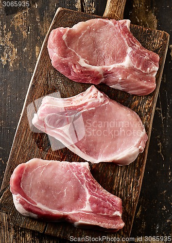 Image of fresh raw meat on wooden cutting board