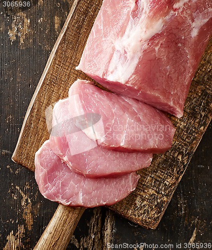 Image of fresh raw meat on wooden cutting board