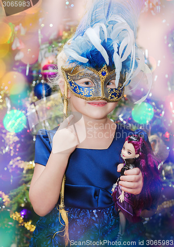 Image of Little blond girl with a carnival mask