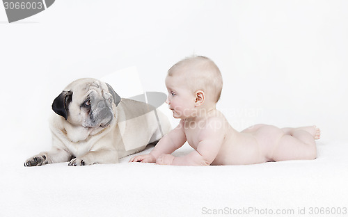 Image of Naked baby lies next to dog