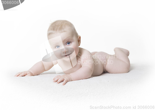 Image of Naked baby laughs into the camera