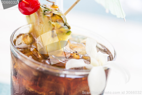 Image of Ice Cold Mai Tai Cocktail Drink with Fruit and Umbrullas