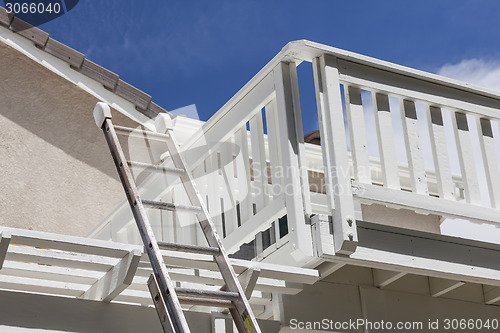 Image of Construction Ladder Leaning on White House Deck