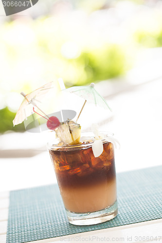 Image of Ice Cold Mai Tai Cocktail Drink with Fruit and Umbrullas