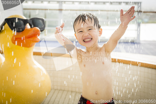 Image of Mixed Race Boy Having Fun at the Water Park