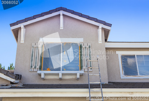 Image of Ladder Leaning Up Against A House Ready For New Paint