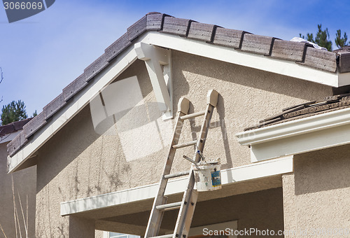 Image of Ladder Leaning Up Against A House Ready For New Paint